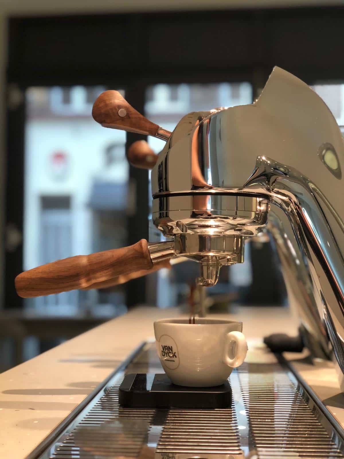 Seitenansicht einer Siebträgermaschine, aus der Kaffee in eine Tasse läuft
