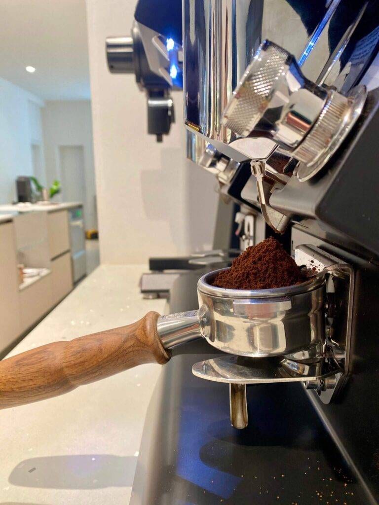 Ein Siebträger wird mit gemahlenem Kaffee gefüllt